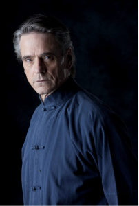 Man staring at camera in blue shirt