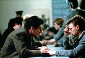 Two men talking across a table 